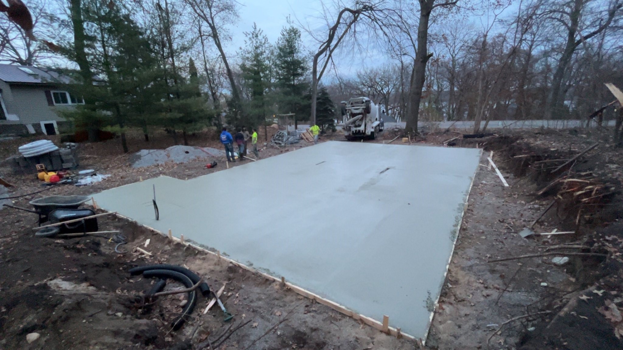 After: finished backyard concrete pad with fire pit cutout