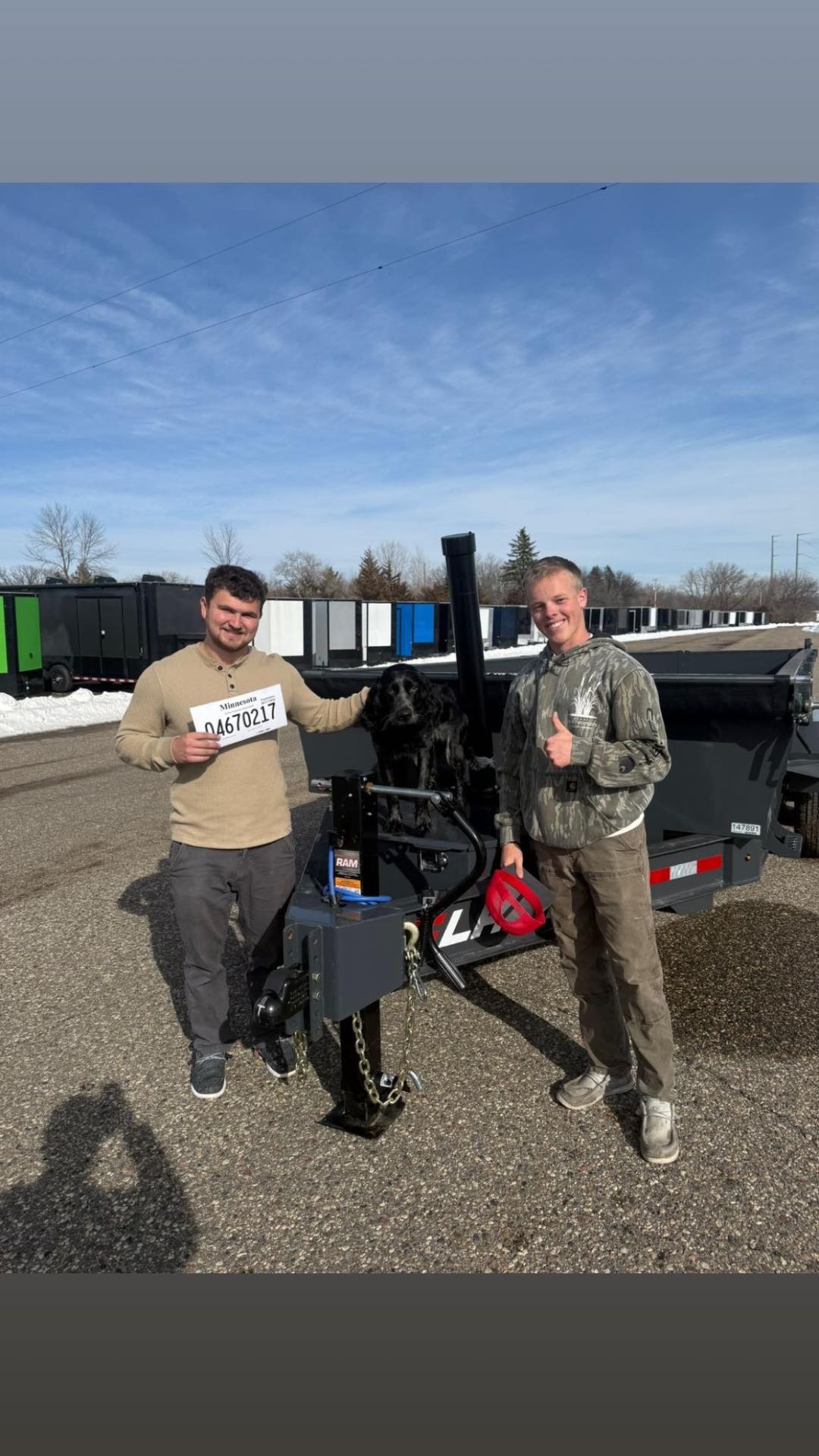 Owners Ayden and Devin standing in front of their company trailer